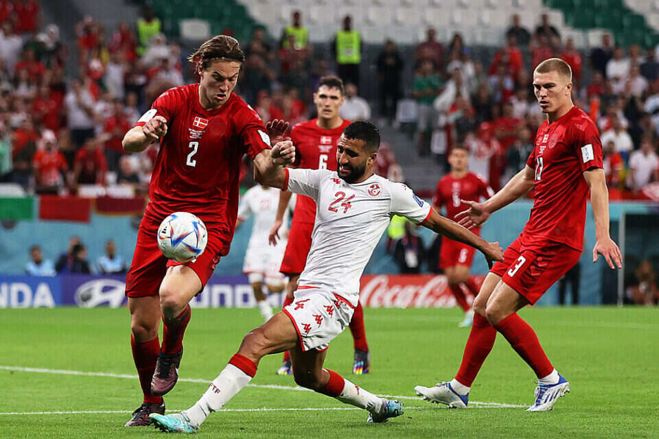 epa10320589 Joachim Andersen (L) of Denmark in action against Ali Abdi (C) of Tunisia during the FIFA World Cup 2022 group D soccer match between Denmark and Tunisia at Education City Stadium in Doha, Qatar, 22 November 2022.  EPA/Abedin Taherkenareh , EPA