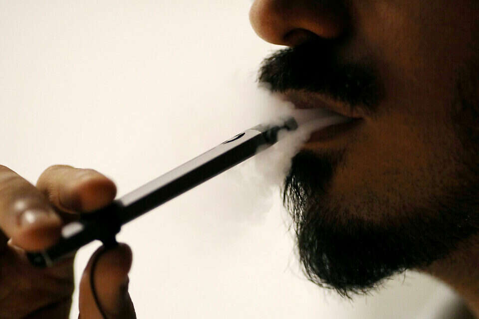 Ali Mansoor, an Emirati vape enthusiast, poses while smoking an e-cigarette at a cafe in Dubai, United Arab Emirates August 22, 2019. Picture taken August 22, 2019. REUTERS/Christopher Pike *** Local Caption *** 10.09.19 , רויטרס