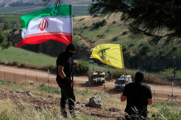 Des membres du Hezbollah agitent le drapeau du Hezbollah et le drapeau de l'Iran à la frontière avec Israël (archives), AP