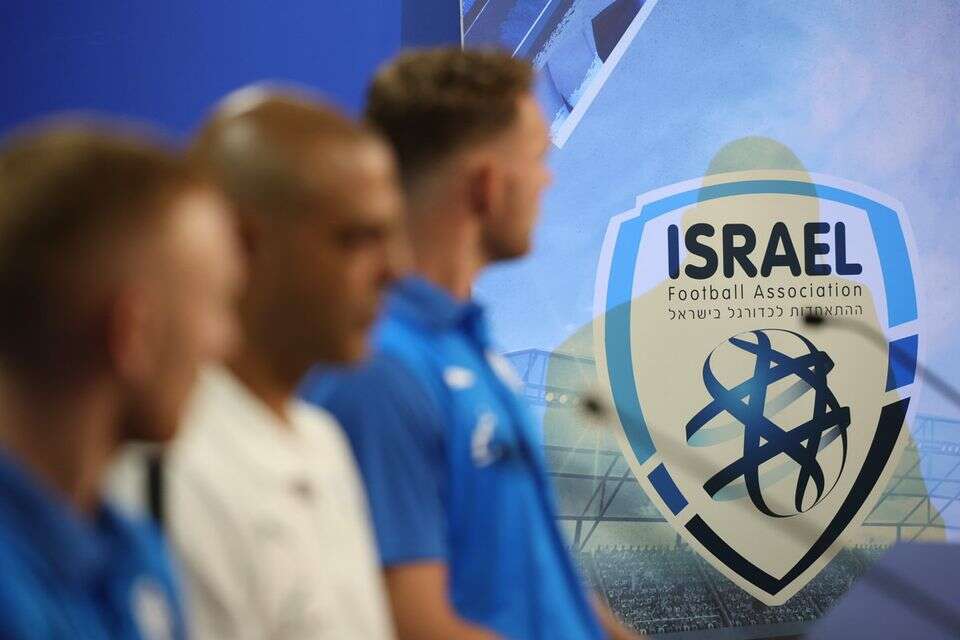 גיא לוזון על רקע סמל ההתאחדות לכדורגל , אלן שיבר
