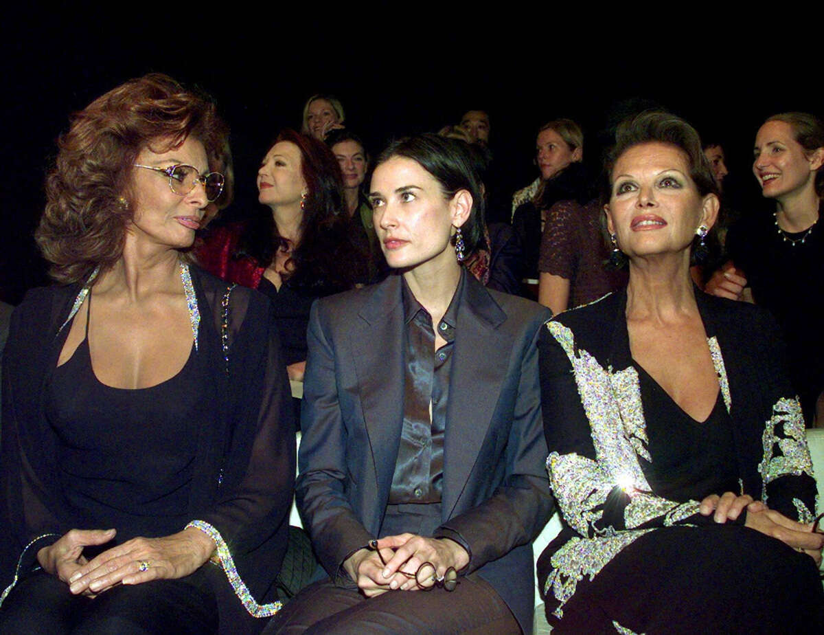 דמי מור (במרכז) לצד סופיה לורן (משמאל) ושחקנית נוספת בתצוגת אופנה של ארמני, 1997 , AP Photo/Luca Bruno, file