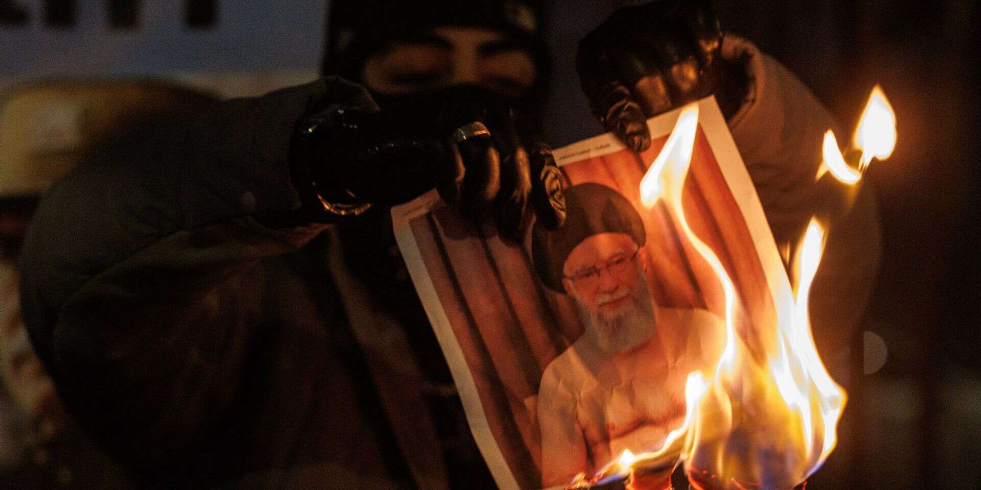 מפגינים שורפים תמונה של חמינאי , GettyImages