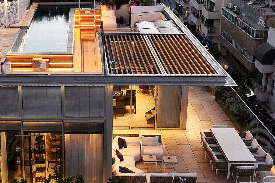 A glimpse of an urban dream: the penthouse in Hamkin with a pool on the roof (and a hanging fireplace in the living room)