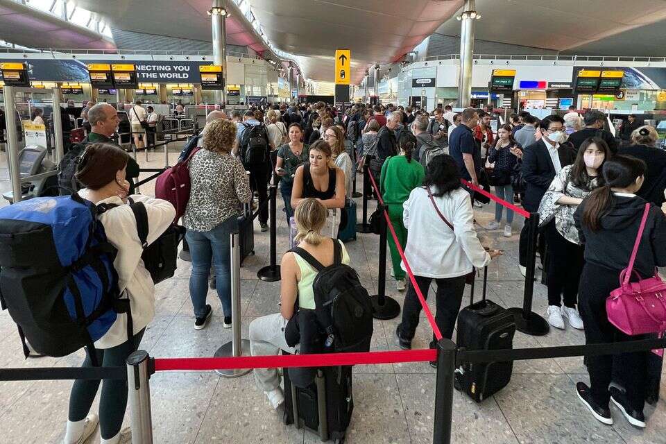 Travellers queue at security at Heathrow Airport in London, Wednesday, June 22, 2022. People face travelling disruption and long queues at airports amid the industry's ongoing staffing crisis. (AP Photo/Frank Augstein) *** Local Caption *** 24.06.22 ? , AP Photo/Frank Augstein