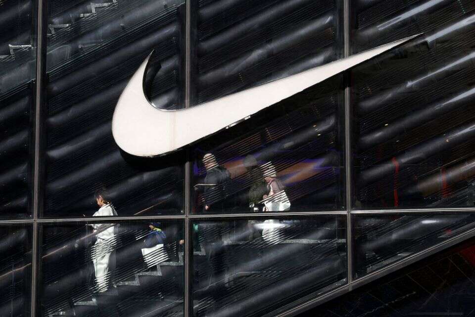FILE PHOTO: People descend stairs inside a Nike store in New York City, U.S., April 2, 2025. REUTERS/Kylie Cooper/File Photo , REUTERS/Kylie Cooper