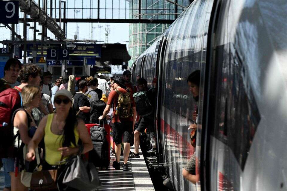 (FILES) Passengers board an ICE (Intercity-Express) train of German rail operator Deutsche Bahn at Frankfurt Central Station (Hauptbahnhof) in Frankfurt am Main, western Germany on June 24, 2026, the day after a breakdown in the railway radio communication system brought trains across the country to a standstill. State-owned German railway operator Deutsche Bahn (DB) announced on July 30, 2026 its first profitable half-year since 2019, and said it expected to remain in the black for the full year. The company made 900 million euros (USD 1.03 billion) more than last year thanks to savings including redundancies, resulting in a net profit of 147 million euros for the first six months of 2026, it said in a statement. Rising passenger numbers also boosted revenue by almost two percent to 13.6 billion euros, helped by the war in the Middle East prompting people to give up "their cars for trains due to rising fuel prices", DB spokesperson Achim Stauss said. (Photo by Kirill KUDRYAVTSEV / AFP) , 