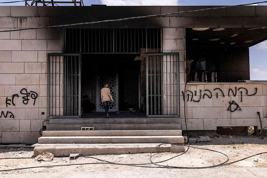 כתובות שרוססו בעברית על אחד הבתים בכפר קוסרה , AFP