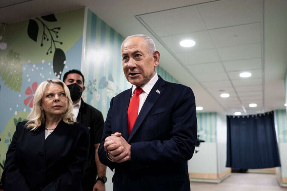 Israel's Prime Minister Benjamin Netanyahu speaks to the media as he stands next to his wife Sara after voting at a polling station in Jerusalem, Tuesday, Oct. 27, 2026. (Jewel Samad/Pool Photo via AP) , AP